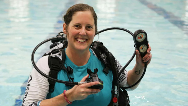 Toft demonstrates some of the gear SCUBA students use.