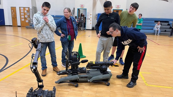 Cape May County Special Services School District students interacting with New Jersey State Police robot dogs.